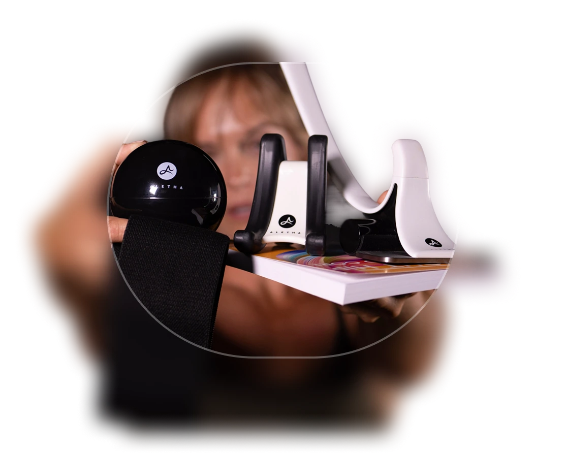 Person using Aletha Health muscle relief device on arm